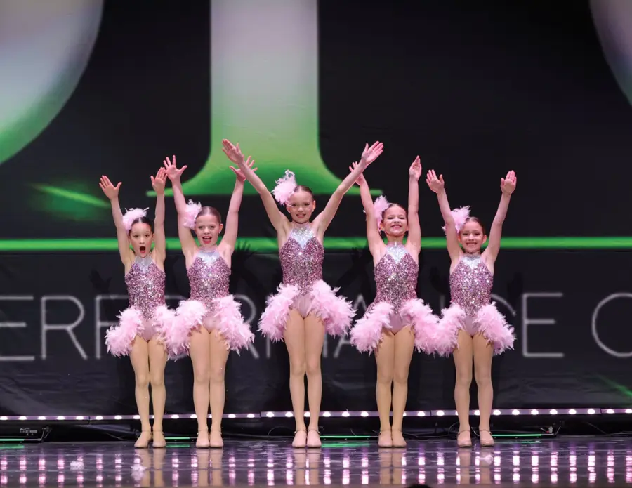 Young dancers in pink tutus posing on the DPC stage