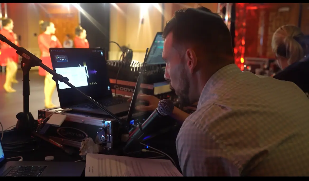 A Visual Sound Productions technician running sound and lights at a DPC event